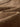 Olvaxe Snow Washed Kids T-Shirt, Folded unprinted fabric microtexture — official garment detail photo; warm-brown appearance reference, not an explicitly labeled Coffee dye