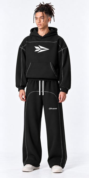 AI-generated styling simulation: close full-length front view of black Olvaxe contrast-stitched sweatpants. Pants only; matching hoodie sold separately; shoes not included.